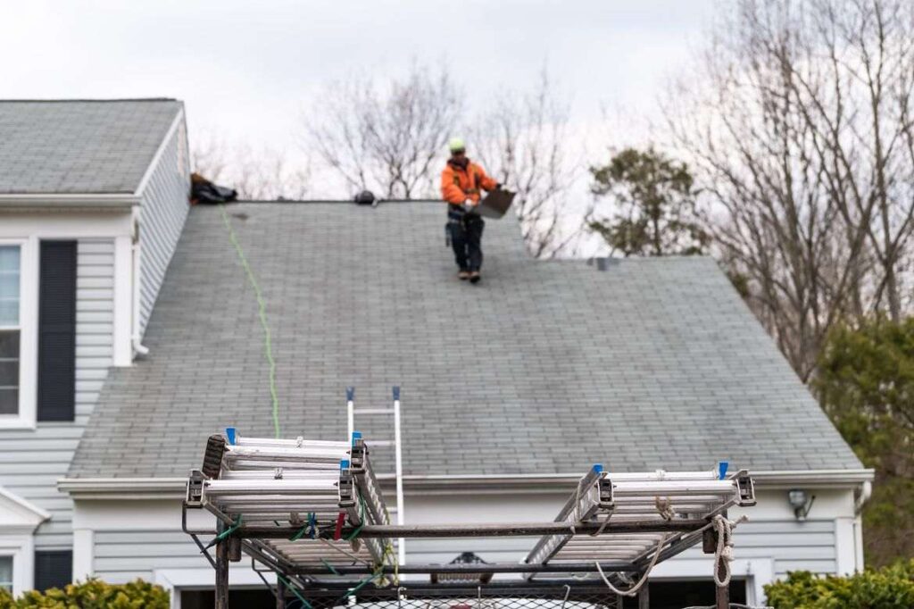 Persons repairing roof