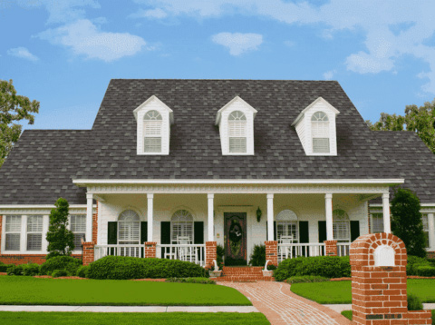 A brick house with a white roof surrounded by green grass is in Orlando, FL 